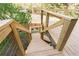 Wooden staircase with metal railing leading down from a deck into the yard at 1924 Sweet Flag Rd, Lawrenceville, GA 30045