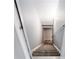 A stairway with carpeting, leading to the basement, is well-lit and has safety rails at 1924 Sweet Flag Rd, Lawrenceville, GA 30045