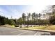 Well-maintained tennis courts surrounded by lush landscaping and parking at 1924 Sweet Flag Rd, Lawrenceville, GA 30045