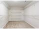 Large walk-in closet with adjustable shelving and carpet flooring at 1924 Sweet Flag Rd, Lawrenceville, GA 30045