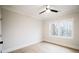 Bright bedroom featuring a ceiling fan, hardwood floors, and a large window at 3128 Cedar St, Scottdale, GA 30079