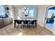 Open concept dining room with modern light fixture and access to the deck at 3128 Cedar St, Scottdale, GA 30079