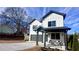 Stylish two-story home with a covered front porch and attached garage, set on a sunny day at 3128 Cedar St, Scottdale, GA 30079
