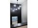 Hallway with black accent wall and modern lighting fixture at 3128 Cedar St, Scottdale, GA 30079