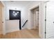 Hallway with wood flooring, black accent wall, decorative light fixture, and white trim at 3128 Cedar St, Scottdale, GA 30079