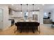 Bright eat-in kitchen features a large island with bar stool seating and modern light fixtures at 3128 Cedar St, Scottdale, GA 30079