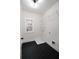 Functional laundry room featuring black wood tile flooring and wire shelving at 3128 Cedar St, Scottdale, GA 30079