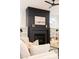 Close up on living room fireplace with tiled hearth, built-ins, and stylish decor at 3128 Cedar St, Scottdale, GA 30079