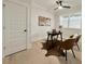 Bright office features hardwood floors, ceiling fan, and natural light from window with blinds at 3128 Cedar St, Scottdale, GA 30079