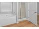 Bathroom features a soaking tub with a stand-up shower at 5125 Cactus Cove Ln, Buford, GA 30519