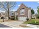 Charming two-story home with brick facade, balcony and attached two-car garage at 5125 Cactus Cove Ln, Buford, GA 30519