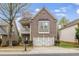 Charming two-story home with brick facade, balcony and attached two-car garage at 5125 Cactus Cove Ln, Buford, GA 30519