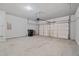 Attached garage with overhead door, ample space, and lighting at 5125 Cactus Cove Ln, Buford, GA 30519