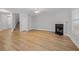 Bright living room features a fireplace, wood flooring, and ample natural light at 5125 Cactus Cove Ln, Buford, GA 30519