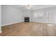 Bright living room features a fireplace, wood flooring, and ample natural light at 5125 Cactus Cove Ln, Buford, GA 30519