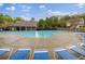 Community pool featuring lounge chairs and a covered seating area, perfect for relaxation and recreation at 5125 Cactus Cove Ln, Buford, GA 30519