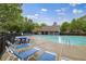 Enjoy the community pool with picnic tables and chairs in a serene environment surrounded by lush greenery at 5125 Cactus Cove Ln, Buford, GA 30519