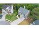 Aerial view of home featuring a long driveway, well-manicured lawn, and professional landscaping in a friendly neighborhood at 7040 Magnolia Park Ln, Norcross, GA 30093
