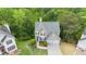 Aerial front view of home with a neutral color palette, a 2-car garage, and well-maintained landscaping at 7040 Magnolia Park Ln, Norcross, GA 30093
