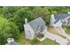 Aerial view of home with a 2-car garage, lush trees and green lawns around the property and surrounding neighborhood at 7040 Magnolia Park Ln, Norcross, GA 30093
