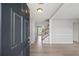Bright entryway featuring wood floors, neutral paint, and an inviting staircase at 7040 Magnolia Park Ln, Norcross, GA 30093