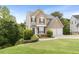 Well-maintained home with a two-car garage, lush green lawn, and inviting front entrance at 7040 Magnolia Park Ln, Norcross, GA 30093