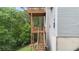 Multi-level wooden deck with view of home's siding at 7040 Magnolia Park Ln, Norcross, GA 30093