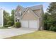 Lovely home featuring a two-car garage, long driveway, and beautifully landscaped yard at 7040 Magnolia Park Ln, Norcross, GA 30093