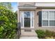 Inviting front entrance featuring a charming covered porch and well-maintained landscaping at 7040 Magnolia Park Ln, Norcross, GA 30093