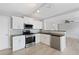 Well-lit kitchen featuring white cabinets, stainless steel appliances, and modern lighting at 7040 Magnolia Park Ln, Norcross, GA 30093