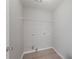 Simple laundry room with hookups and space for appliances and storage at 7040 Magnolia Park Ln, Norcross, GA 30093