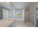 Bright main bathroom showcasing a soaking tub, shower, and neutral colors at 7040 Magnolia Park Ln, Norcross, GA 30093