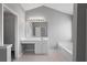 Bright main bathroom with large vanity, soaking tub, and tile flooring at 7040 Magnolia Park Ln, Norcross, GA 30093