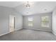 Spacious main bedroom featuring vaulted ceilings, neutral paint, and plush gray carpeting at 7040 Magnolia Park Ln, Norcross, GA 30093