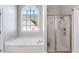 Bright bathroom with a jacuzzi tub, separate shower and large window at 2006 Hubbard Ct, Villa Rica, GA 30180