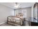 Comfortable bedroom with a decorative wrought iron bed frame, dresser, and plenty of natural light at 2006 Hubbard Ct, Villa Rica, GA 30180