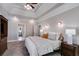 Spacious main bedroom featuring tray ceiling, carpet, and bedside tables with lamps at 2006 Hubbard Ct, Villa Rica, GA 30180