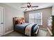 This bedroom features a wooden bed frame, ceiling fan, natural light, and warm neutral paint at 2006 Hubbard Ct, Villa Rica, GA 30180