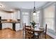 Cozy breakfast nook with hardwood floors, bay windows, and charming chandelier at 2006 Hubbard Ct, Villa Rica, GA 30180