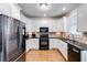 Bright kitchen with white cabinets, black countertops, and stainless steel appliances at 2006 Hubbard Ct, Villa Rica, GA 30180