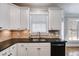 Well-lit kitchen featuring white cabinets, granite countertops and black appliances at 2006 Hubbard Ct, Villa Rica, GA 30180