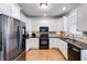 Bright kitchen with white cabinets, black countertops, and stainless steel appliances at 2006 Hubbard Ct, Villa Rica, GA 30180