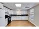 Kitchen featuring white cabinets, modern appliances, and hardwood floors at 2006 Hubbard Ct, Villa Rica, GA 30180
