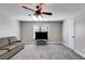 Cozy living room with plush carpeting, a ceiling fan, and a comfortable sofa, perfect for relaxation at 2006 Hubbard Ct, Villa Rica, GA 30180