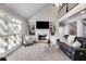 Spacious living room with built-in bookshelves, a fireplace, and a large window at 2006 Hubbard Ct, Villa Rica, GA 30180