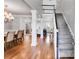 Open-concept living room with hardwood floors, decorative columns, staircase, and natural light at 2006 Hubbard Ct, Villa Rica, GA 30180