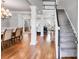 Open-concept living room with hardwood floors, decorative columns, staircase, and natural light at 2006 Hubbard Ct, Villa Rica, GA 30180