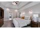 Bright bedroom features a trey ceiling, a ceiling fan, sconce lighting, and carpeted floors at 2006 Hubbard Ct, Villa Rica, GA 30180