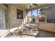 Cozy screened porch with seating and an umbrella table, perfect for outdoor dining at 2006 Hubbard Ct, Villa Rica, GA 30180