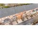 Aerial view of a neighborhood featuring brick townhomes with wooden decks and attached garages at 2620 Milford Ln, Alpharetta, GA 30009